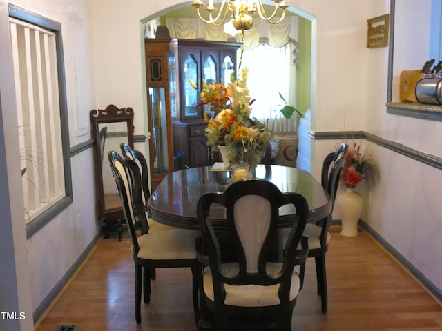 dining space featuring a notable chandelier and hardwood / wood-style flooring