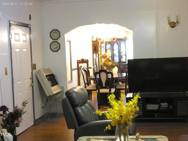 living room featuring wood-type flooring and a chandelier