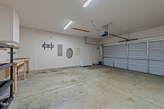 garage with a garage door opener and electric panel