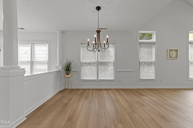 unfurnished dining area with a chandelier, light wood-style floors, decorative columns, and visible vents