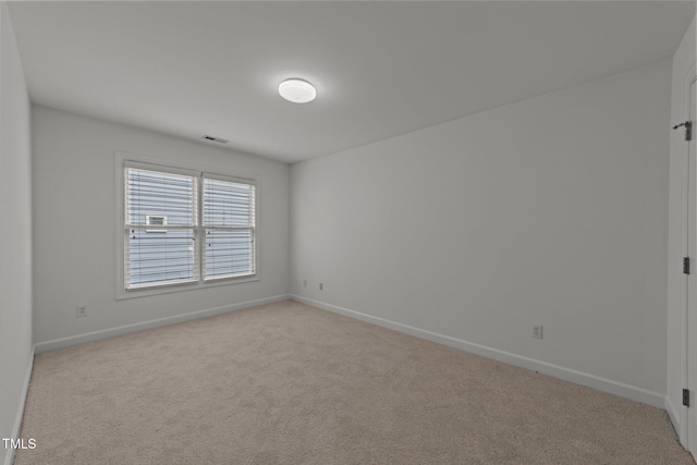 unfurnished room featuring light colored carpet, baseboards, and visible vents