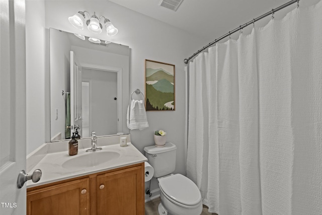full bath with toilet, vanity, and visible vents