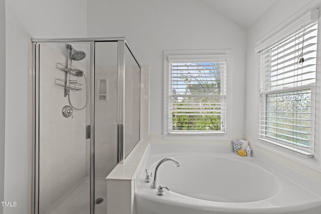 bathroom with a shower stall, a garden tub, and a healthy amount of sunlight