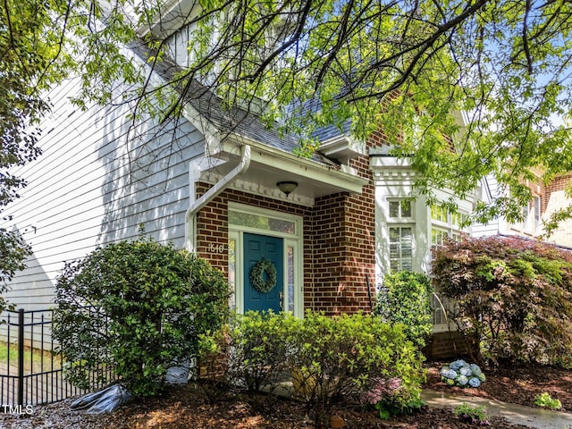 doorway to property with brick siding