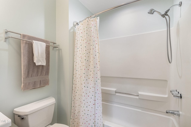 bathroom featuring shower / bath combo and toilet