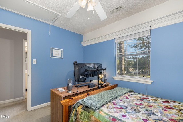 bedroom featuring ceiling fan, light colored carpet, and a textured ceiling