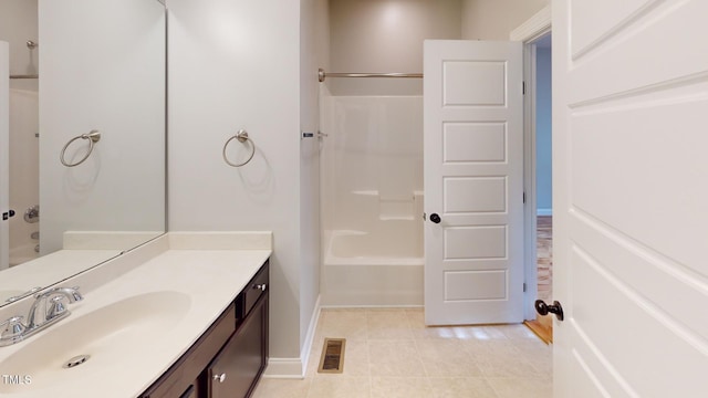 bathroom featuring tile patterned flooring, vanity, and washtub / shower combination