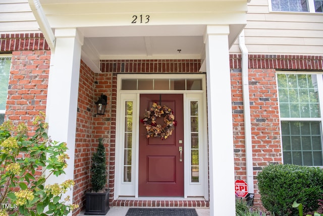 view of exterior entry featuring a porch