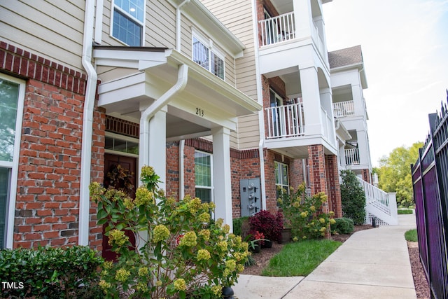 view of exterior entry with a balcony