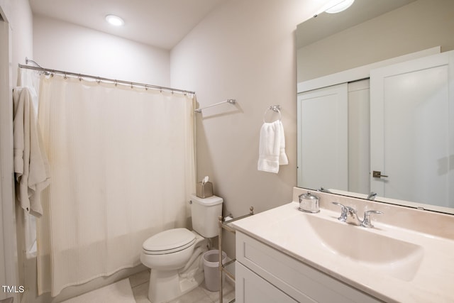 bathroom with vanity, toilet, curtained shower, and tile patterned floors