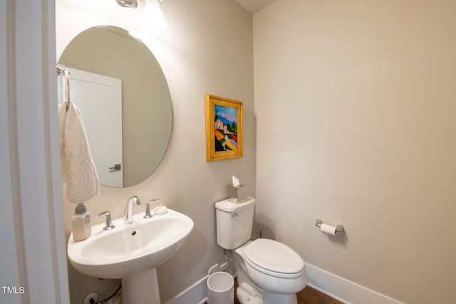 bathroom featuring toilet and sink