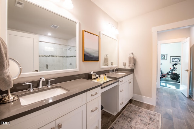 bathroom featuring a shower with door, vanity, and hardwood / wood-style floors