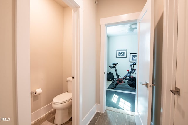 bathroom with toilet and hardwood / wood-style flooring