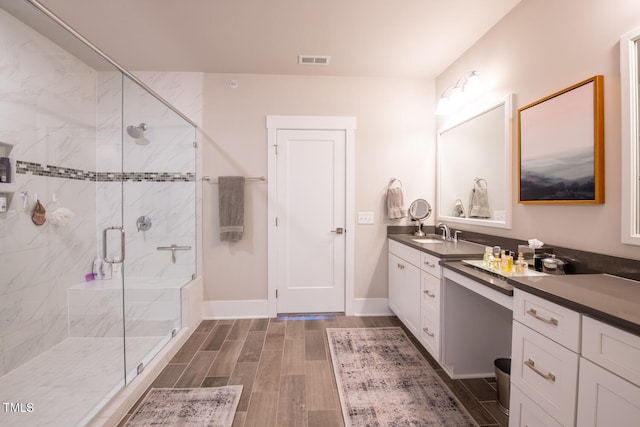 bathroom with vanity, hardwood / wood-style floors, and walk in shower