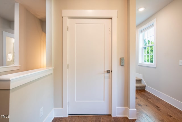 hall with wood-type flooring