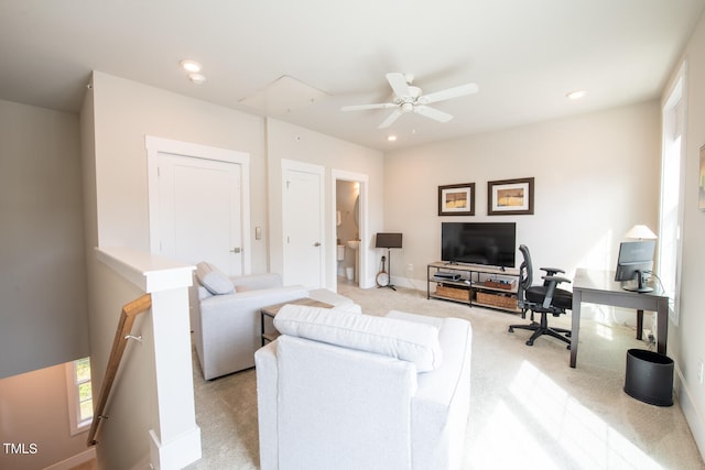 living room featuring light colored carpet and ceiling fan