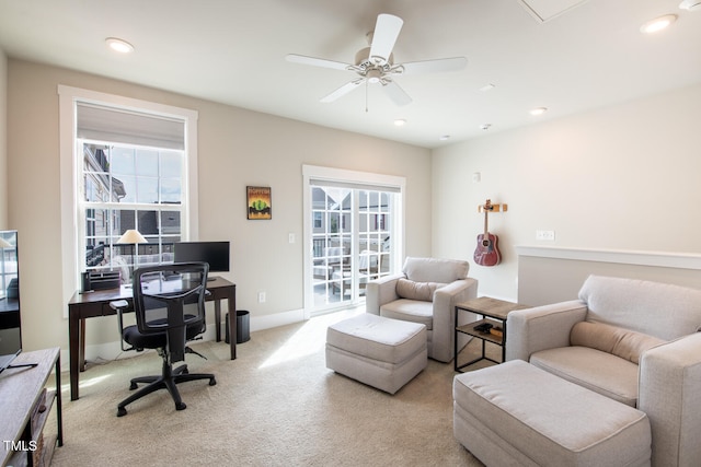 office space featuring ceiling fan and light carpet