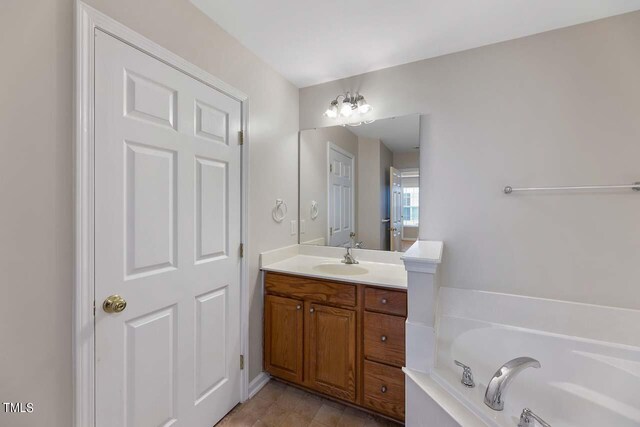 bathroom with vanity and a tub