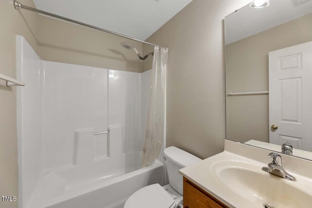 full bathroom featuring vanity, shower / tub combo, and toilet