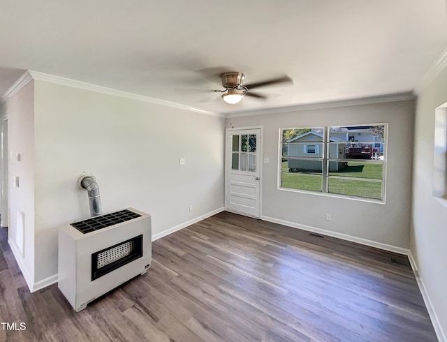 interior space with hardwood / wood-style floors, ceiling fan, crown molding, and heating unit