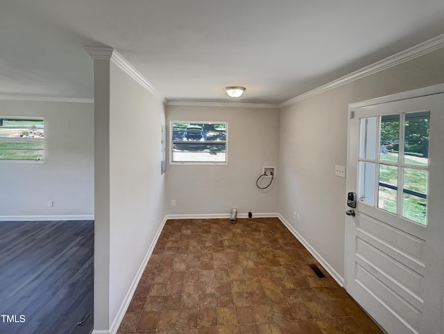 interior space with a wealth of natural light, visible vents, baseboards, and ornamental molding