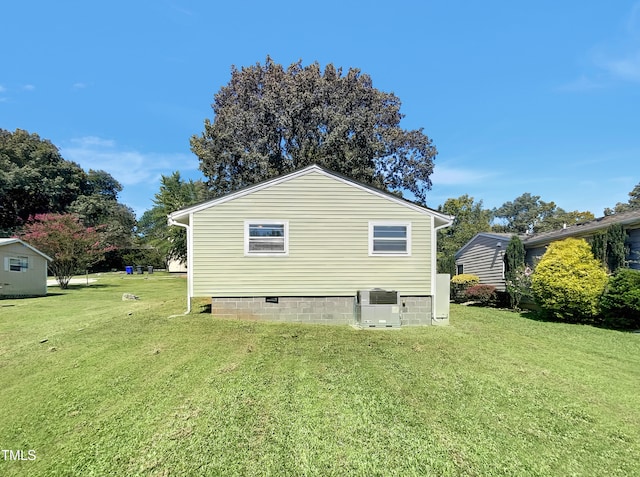 view of home's exterior with a lawn and cooling unit