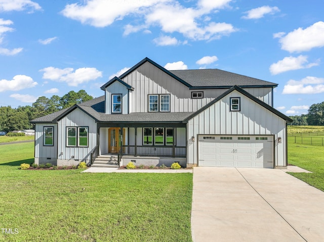 modern inspired farmhouse with a porch, a garage, and a front lawn