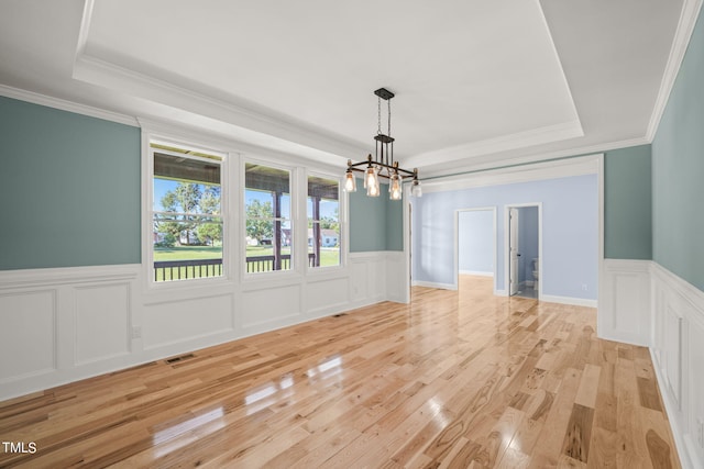 2804 Jack Mitchell Rd, Zebulon, NC 27597 - unfurnished dining area with a wainscoted wall, visible vents, a chandelier, light wood finished floors, and a raised ceiling