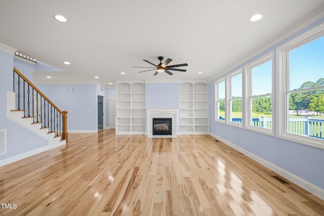 2804 Jack Mitchell Rd, Zebulon, NC 27597 - unfurnished living room with light wood finished floors, baseboards, ornamental molding, and a ceiling fan