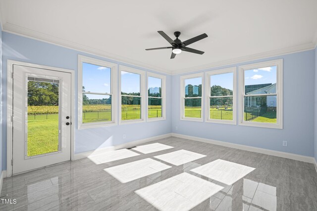 unfurnished sunroom featuring ceiling fan