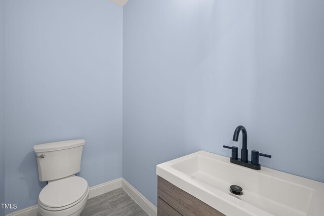 2804 Jack Mitchell Rd, Zebulon, NC 27597 - bathroom featuring baseboards, toilet, and vanity