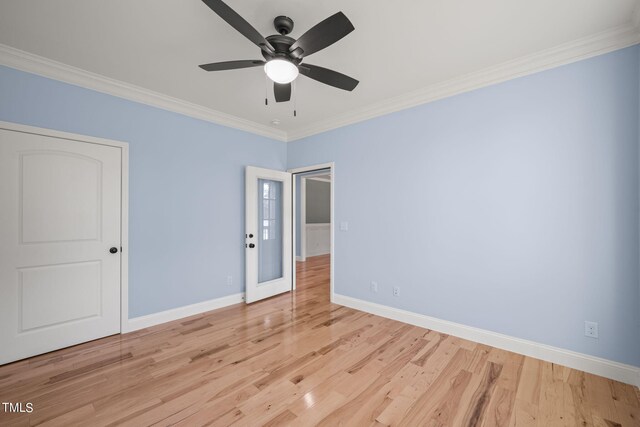 unfurnished room with ceiling fan, light hardwood / wood-style floors, and crown molding