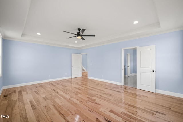 2804 Jack Mitchell Rd, Zebulon, NC 27597 - empty room with a tray ceiling, crown molding, and light wood-type flooring