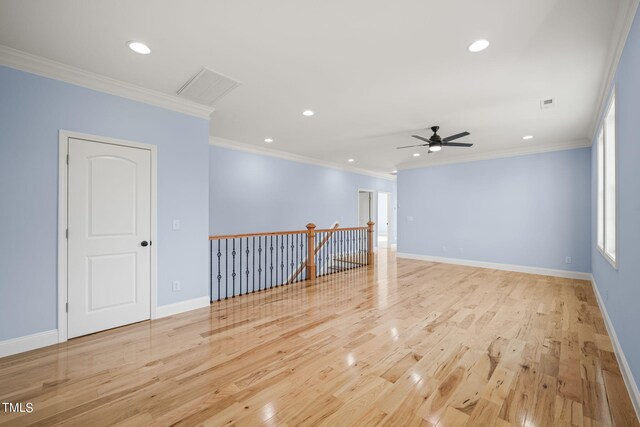 empty room with light wood-type flooring, ceiling fan, and crown molding