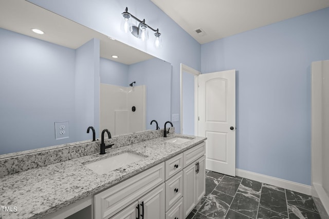 2804 Jack Mitchell Rd, Zebulon, NC 27597 - bathroom with marble finish floor, a sink, baseboards, and visible vents