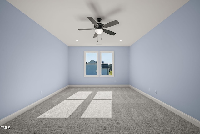 spare room featuring ceiling fan and light carpet