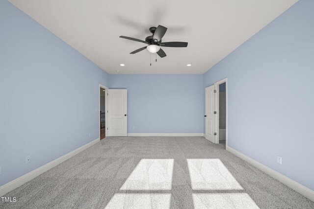 spare room featuring ceiling fan and light carpet