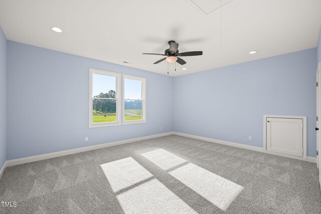 carpeted spare room featuring ceiling fan