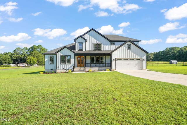 2804 Jack Mitchell Rd, Zebulon, NC 27597 - modern farmhouse with board and batten siding, a front yard, driveway, and a garage