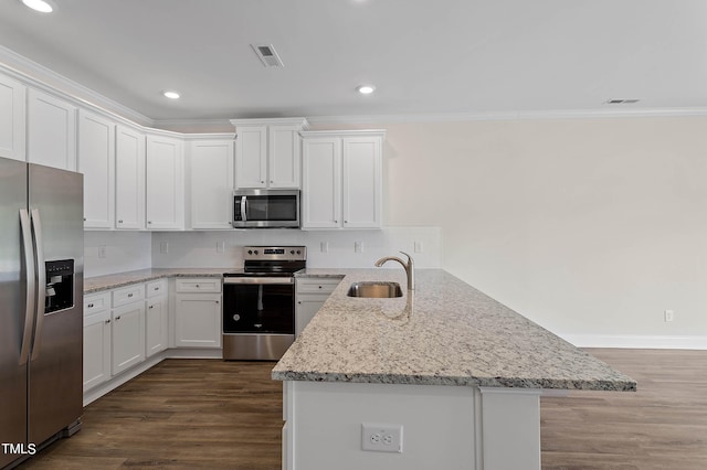 kitchen with light stone counters, sink, dark hardwood / wood-style floors, appliances with stainless steel finishes, and white cabinets