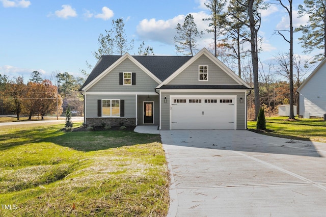 view of front of home featuring a front lawn and a garage