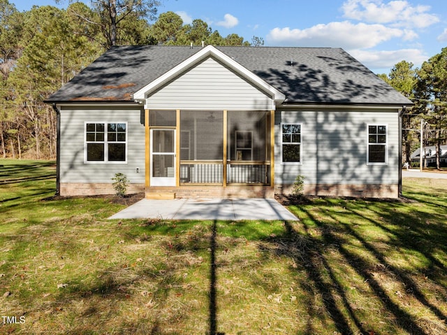 rear view of property featuring a lawn, a patio area, and a sunroom