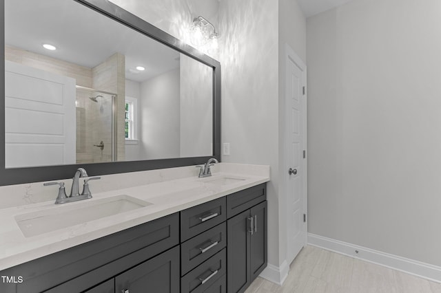 bathroom with vanity and a shower with door