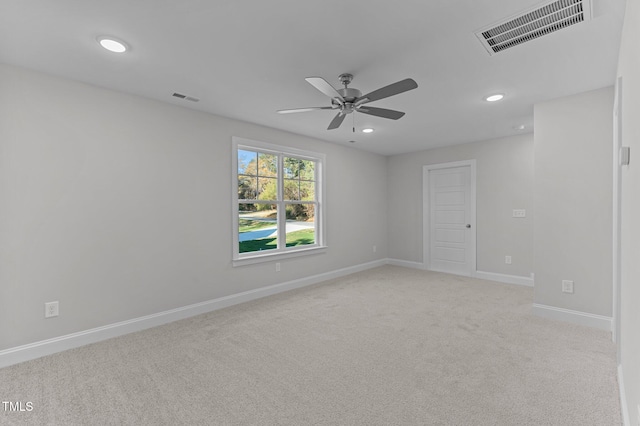 empty room with ceiling fan and light colored carpet