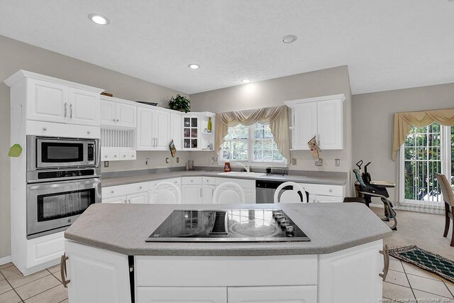 kitchen featuring white cabinets, a center island, and stainless steel appliances