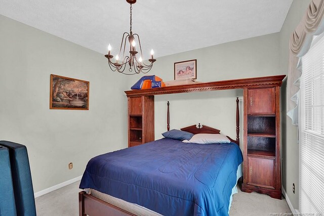 carpeted bedroom with multiple windows and a chandelier