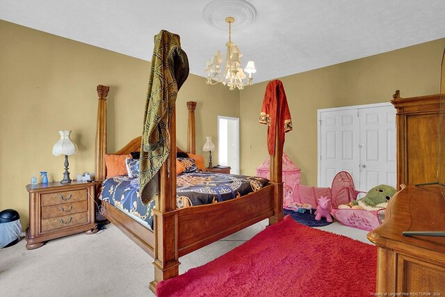 carpeted bedroom with an inviting chandelier