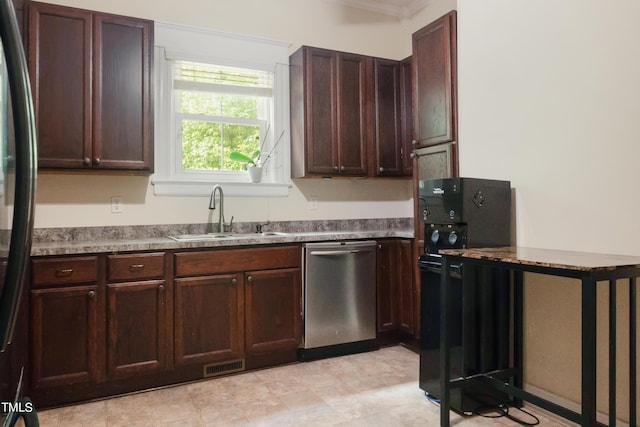 kitchen featuring visible vents, black fridge, a sink, dark brown cabinets, and dishwasher
