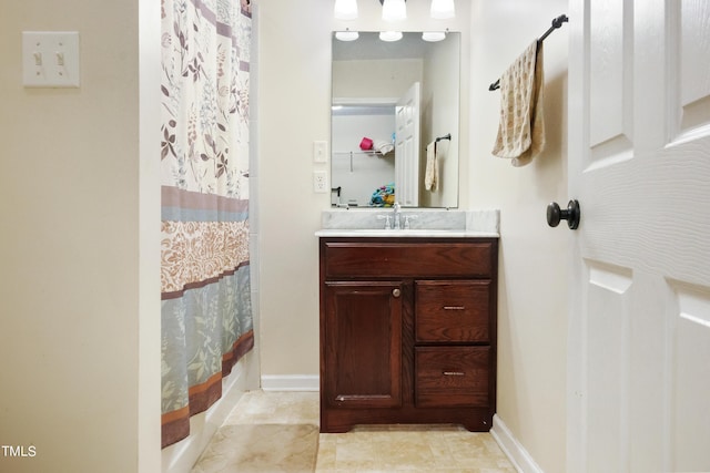 bathroom featuring baseboards, vanity, and a shower with curtain