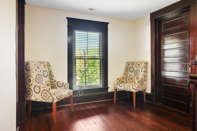 unfurnished room featuring visible vents, baseboards, and wood finished floors